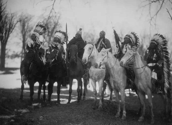 Six tribal leaders (l to r) Little Plume (Piegan), Buckskin Charley (Ute), Geronimo (Chiricahua Apache), Quanah Parker (Comanche), Hollow Horn Bear (Brulé Sioux), and American Horse (Oglala Sioux) on horseback in ceremonial attire. 