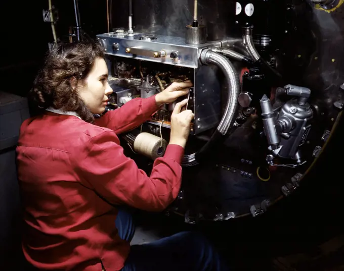 Switch boxes on the firewalls of B-25 bombers are assembled by women workers at North American Aviation, Inc.'s Inglewood, Calif., plant - October 1942. 