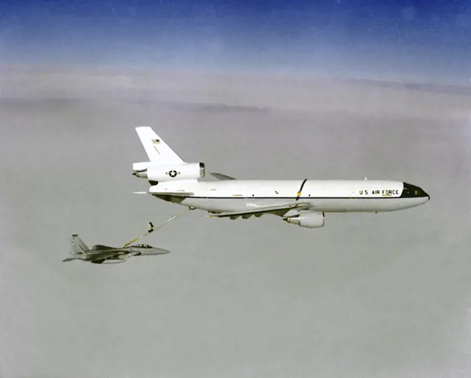 Air-to-air right side view of a KC-10A Extender aircraft refueling an F-15A Eagle aircraft.. 