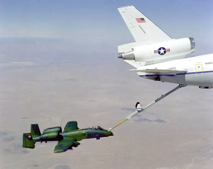 An overhead right side view of an A-10A Thunderbolt aircraft undergoing in-flight refueling through the boom of a KC-10A Extender aircraft.. 