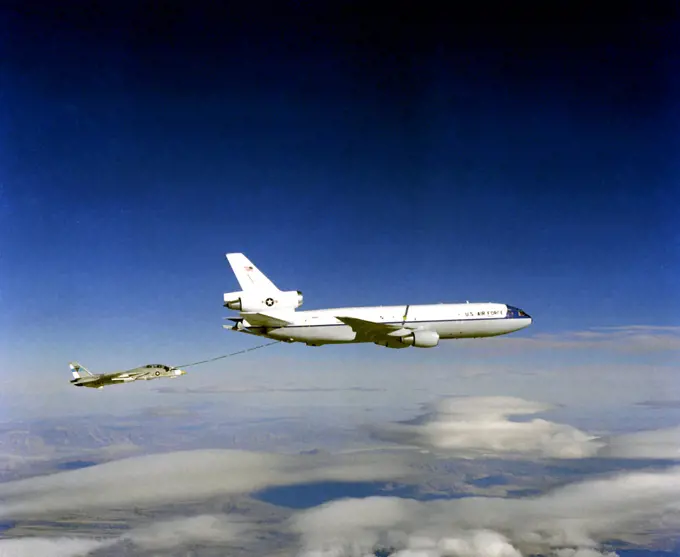 1982 - Air-to-air right side view of a KC-10A Extender aircraft refueling an F-14 Tomcat aircraft.. 