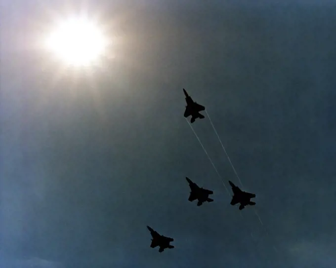 1980 - Four F-15 Eagle aircraft execute a Missing Man formation as they fly over the Pentagon during Memorial Day services.. 