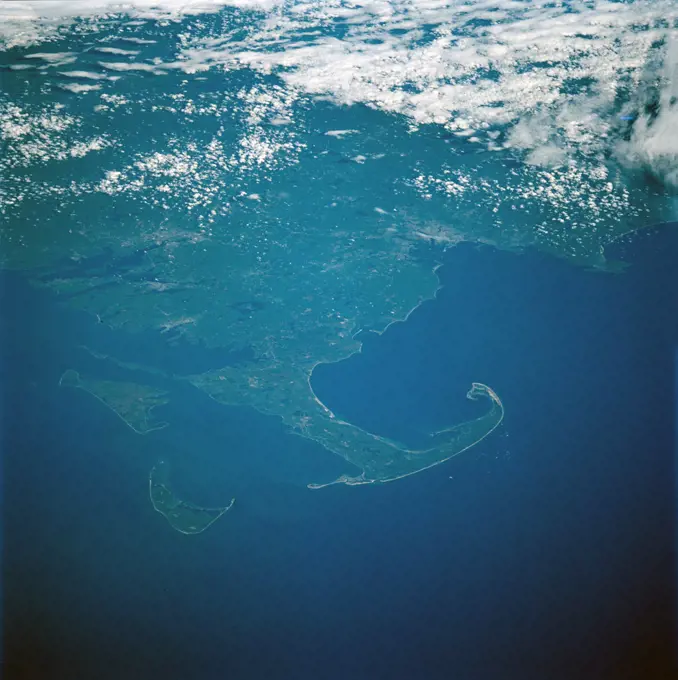 (15-24 May 1997) --- Cape Cod extends 105 kilometers (65 miles) into the Atlantic Ocean.  To the south of Cape Cod are the islands of Martha's Vineyard (west) and Nantucket (east).  The city of Boston can be seen surrounding the bay above the 'hook' on Cape Cod.  To the south are the cities of New Bedford on Buzzards Bay, and Providence, Rhode Island.  The Cape Cod Canal is an artificial waterway that connects Buzzards Bay and Cape Cod Bay.  The waterway is 28 kilometers (17.5 miles) and does not contains locks.  The canal was built to shorten the distance over water between New York City and Boston.  In 1620 the Pilgrims landed at Provincetown, on the upper tip of Cape Cod, before they proceeded to Plymouth.. 