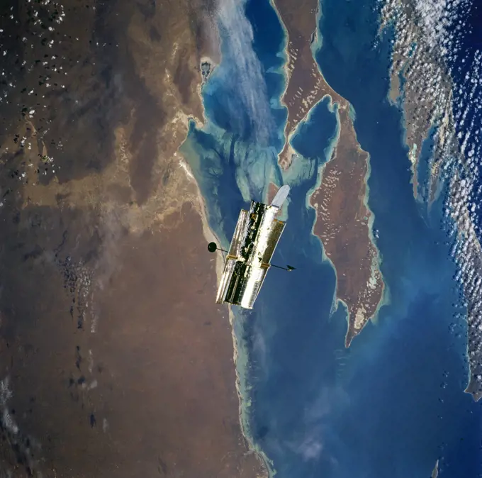 (11-21 Feb. 1997) --- This nearly-vertical view, photographed from the Space Shuttle Discovery, shows the Hubble Space Telescope (HST) over Shark Bay. Shallowest parts of the bay appear light blue. In this view of Australia's arid west, sets of sand dunes are clearly visible on Peron Peninsula (lower center) from southwest to northeast (bottom left to top right), blown by the prevailing wind.  Hartog Island lies bottom right.. 