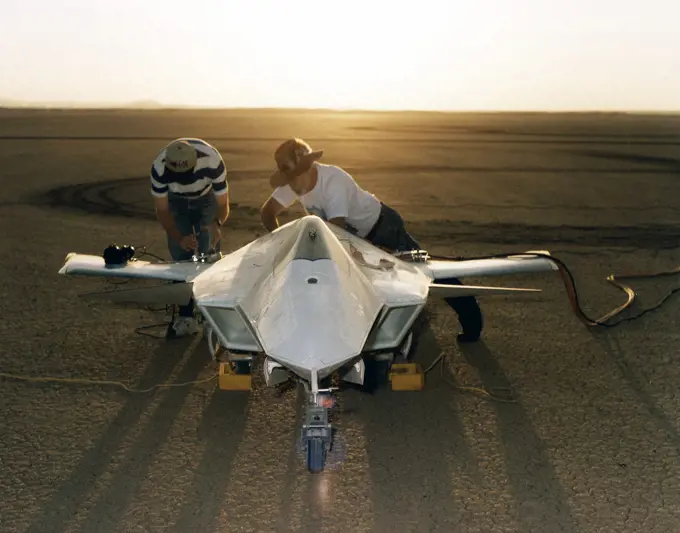 As the sun creeps above the horizon of Rogers Dry Lake at NASA's Dryden Flight Research Center, Edwards, California, technicians make final preparations for the first flight of the X-36 Tailless Fighter Agility Research Aircraft.. 