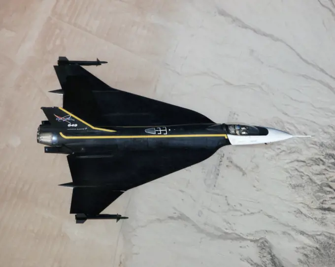 An image of the F-16XL #1 during its functional flight check of the Digital Flight Control System (DFCS) on December 16, 1997. The mission was flown by NASA research pilot Dana Purifoy, and lasted 1 hour and 25 minutes. The tests included pilot familiarly, functional check, and handling qualities evaluation maneuvers to a speed of Mach 0.6 and 300 knots. Purifoy completed all the briefed data points with no problems, and reported that the DFCS handled as well, if not better than the analog computer system that it replaced.. 