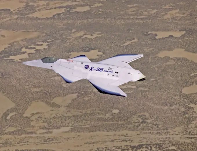 The unusual lines of the X-36 technology demonstrator contrast sharply with the desert floor as the remotely piloted aircraft scoots across the California desert at low altitude during a research flight on October 30, 1997.. 