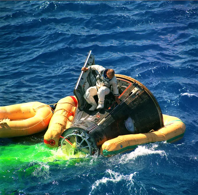 Astronaut Charles Conrad Jr., command pilot of the Gemini 11 space mission, climbs from the spacecraft minutes after splashdown. 