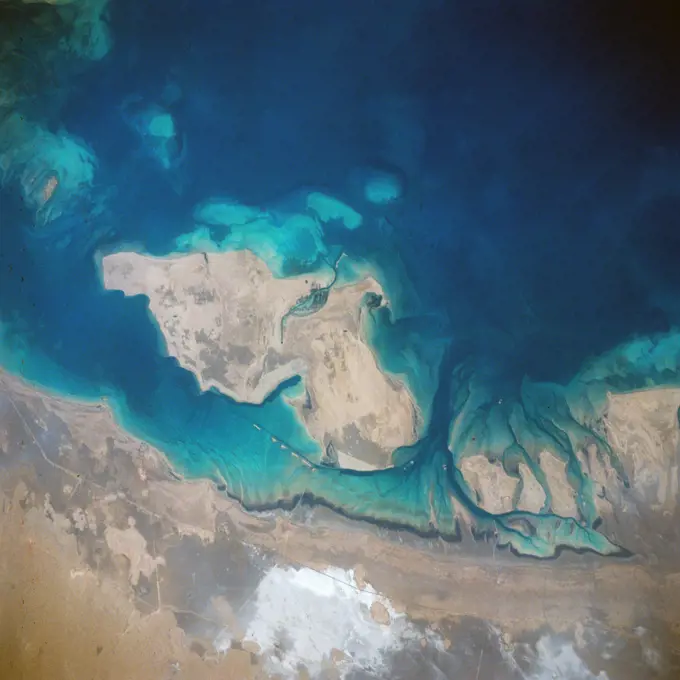 (28 April-6 May 1991) ---  A handheld 70mm frame of the southern Persian Gulf area. The island in the middle of the frame is Al Jirab, 30 miles west of Abu Dhabi in the United Arab Emirates.  On the mainland beaches opposite the island, a thick and continuous black fringe of oil can be seen as a line.  Photo experts studying the STS 39 photography have not yet ascertained the source of the oil.  They disclosed that if the oil does in fact stem from damaged Kuwaiti offshore oil fields, the slick has been blown southward at least 460 miles.  The city of Tarif is visible in the affected area. Lighter brown slicks can be seen offshore.  A causeway joins Al Jirab to the mainland and a dredged ship channel with its associated islands can be seen west of the causeway.. 