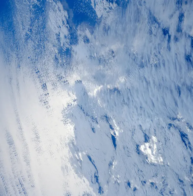 (28 April-6 May 1991) --- A variety of stratus clouds is represented in this picture. The clouds are backdropped against the sunglinted northern Pacific Ocean.  One of Discovery's seven crewmembers aimed a 70mm handheld camera through an overhead window on the aft flight deck to obtain the image.. 