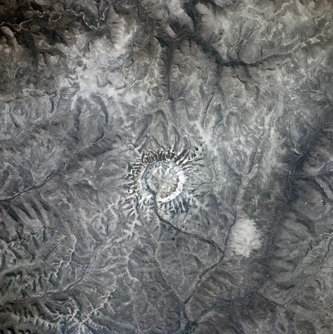 (28 April-6 May 1991) --- In the center of this 70mm frame, surrounded by mountainous terrain, is Gora Konder crater in the USSR.  The 57-degree inclination of Discovery's orbit allowed photographs of seldom observed areas of Earth such as this.  The picture was exposed with a 70mm handheld camera from overhead windows on Discovery's aft flight deck.. 