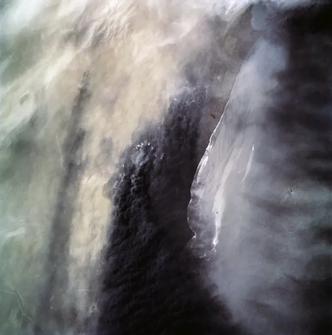 (28 April-6 May 1991) --- A handheld 70mm camera onboard the Space Shuttle Discovery exposed this infrared frame showing oil fires near the Kuwait coast as well as south-bound oil slicks in the Gulf. Pools of oil on the land are recognized as white objects near the burning wells.. 