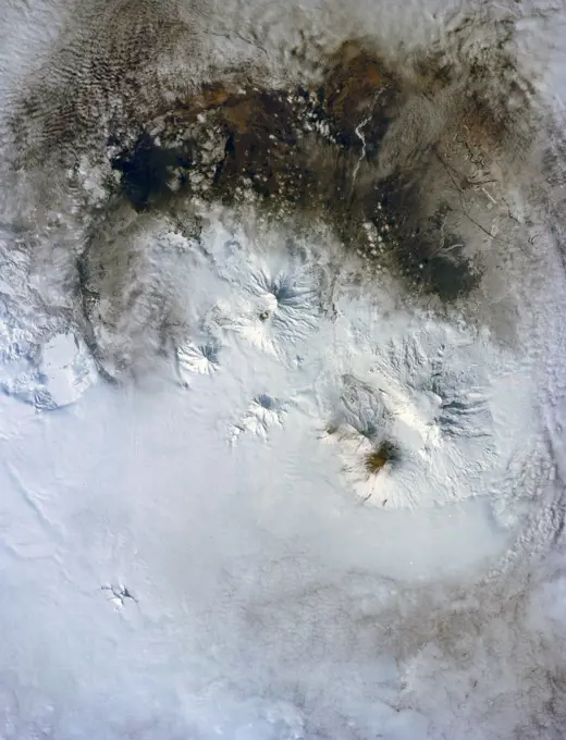 (28 April-6 May 1991) --- A large format frame of one of the USSR's volcanic complex (Kamchatka area) with the active volcano Klyuchevskaya (Kloo-chevs'-ska-ya), 15,584 feet in elevation.  The last reported eruption of the volcano was on April 8, but an ash and steam plume extending to the south was observed by the STS-39 crew almost three weeks later. The south side of the volcano is dirty from the ash fall and landslide activity.  The summit is clearly visible, as is the debris flow from an earlier eruption.  Just north of the Kamchatka River is Shiveluch, a volcano which was active in early April.  There are more than 100 volcanic edifices recognized on Kamchatka, with 15 classified as active.. 