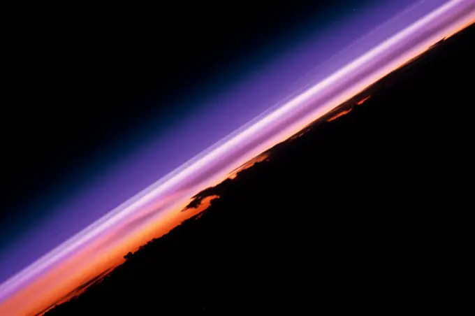 (12 - 20 Sept 1992) --- The colors in this photograph provide insight into the relative density of the atmosphere.  The crew members had many opportunities to witness sunrises and sunsets, considering they orbit the Earth every 90 minutes, but few, they said, compared to this scene.  It captures the silhouette of several mature thunderstorms with their cirrus anvil tops spreading out against the tropopause (the top of the lowest layer of Earth's atmosphere) at sunset.  The lowest layer (troposphere) is the densest and refracts light at the red end of the visible spectrum (7,400 Angstroms), while the blues (4,000 Angstroms) are separated in the least dense portion of the atmosphere (middle and upper atmosphere, or stratosphere and mesosphere).  Several layers of blue can be seen.  . 