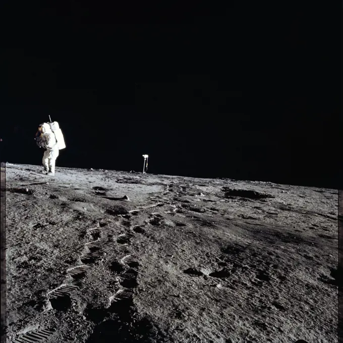 (19 Nov. 1969) --- Astronaut Alan L. Bean, lunar module pilot for the Apollo 12 lunar landing mission, walks from the color lunar surface television camera (center) toward the Apollo 12 Lunar Module (LM - out of frame). The photograph was taken by astronaut Charles Conrad Jr., commander, during the first extravehicular activity (EVA) of the mission. While astronauts Conrad and Bean descended in the LM 'Intrepid' to explore the Ocean of Storms region of the moon, astronaut Richard F. Gordon Jr., command module pilot, remained with the Command and Service Modules (CSM) 'Yankee Clipper' in lunar orbit. . 