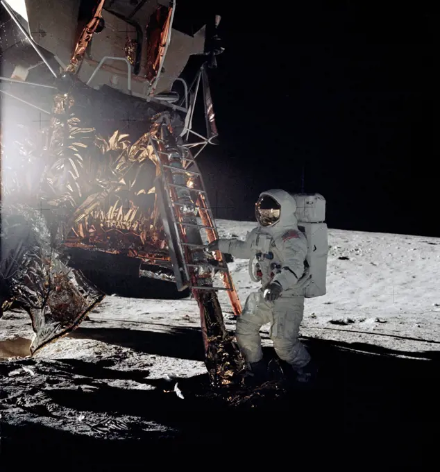 Astronaut Alan L. Bean, lunar module pilot for the Apollo 12 lunar landing mission, steps from the ladder of the Lunar Module to join astronaut Charles Conrad Jr., commander, in extravehicular activity on Nov. 19, 1969.. 