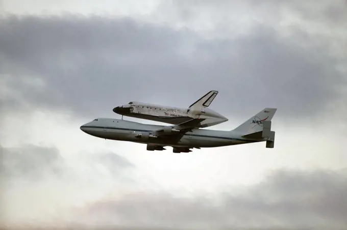 CAPE CANAVERAL, Fla. - Space shuttle Discovery, mounted to a Shuttle Carrier Aircraft, flies toward Cocoa Beach and Patrick Air Force Base after taking off from the Shuttle Landing Facility at NASA's Kennedy Space Center in Florida.