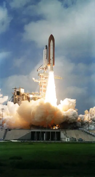 (22 March 1982) --- The space shuttle Columbia, with its third crew aboard, two solid rocket boosters (SRB) and external fuel tank (ET) are photographed as they clear the launch pad at Kennedy Space Center's Launch Complex 39. Astronauts Jack R. Lousma, STS-3 commander, and C. Gordon Fullerton, pilot, were in Earth orbit some ten minutes later looking ahead to seven days of work in space. The external tank is unpainted for the first time, appearing a dark orange in the color photos and dark gray in black and white.