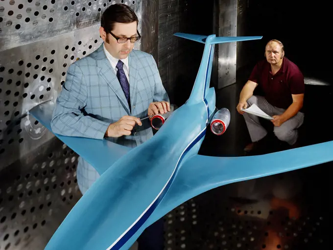 A researcher examines an Advanced Technology Transport model installed in the 8- by 6-Foot Supersonic Wind Tunnel at the National Aeronautics and Space Administration (NASA) Lewis Research Center. ca. 1973