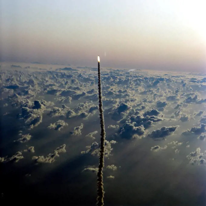 Aerial views of the STS-5 launch from T-38 chase aircraft Nov. 11, 1982. Shuttle Columbia can be seen as a small figure trailed by a line of smoke.