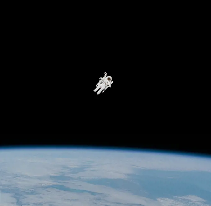 (7 Feb 1984) --- Astronaut Bruce McCandless II approaches his maximum distance from the Earth-orbiting Space Shuttle Challenger in this 70mm frame photographed by his fellow crewmembers onboard the reusable vehicle.