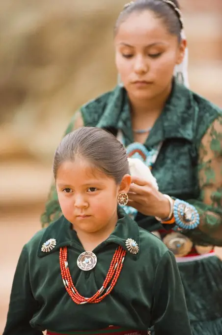 Navajo Indian mother combs her daughter's hair, Gallup Inter-Tribal Indian Ceremonial, Gallup, New Mexico