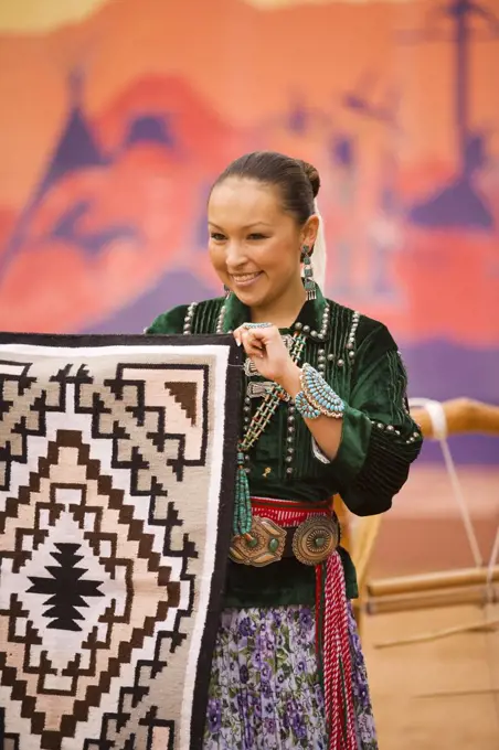 Navajo Indian woman displays a Navajo rug, Gallup Inter-Tribal Indian Ceremonial, Gallup, New Mexico