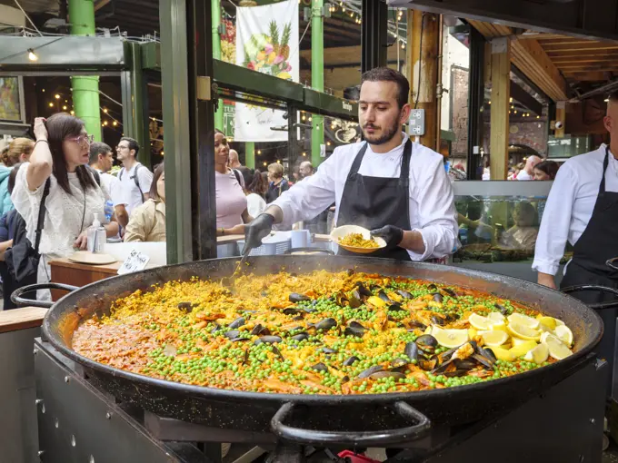 Spanish paella food stall at Borough Market, London, UK.