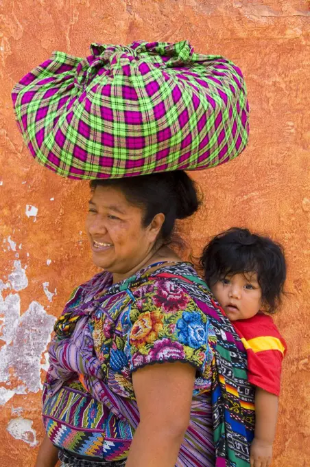 Guatemala, Antigua, Woman Carrying Baby On Back