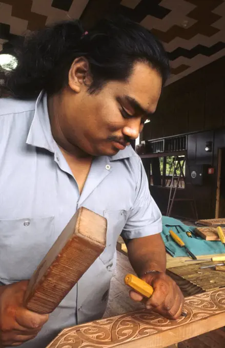 Maori Artist Carving Wood In His Studio At Rotorua, New Zealand