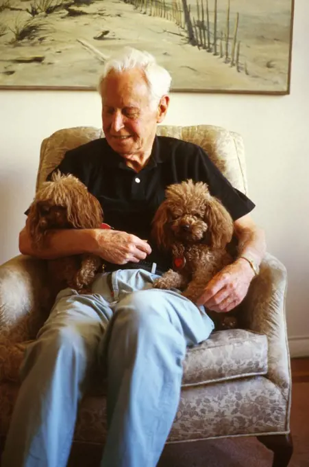 Man Holding His Two Poodles