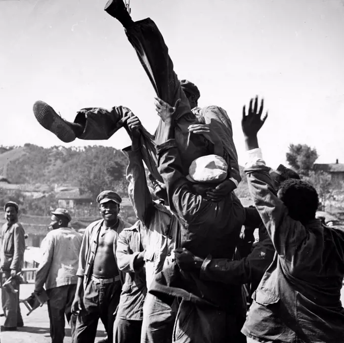 Korean War. American prisoners in a North Korean POW camp celebrating upon hearing news of the armistice. August 1953.