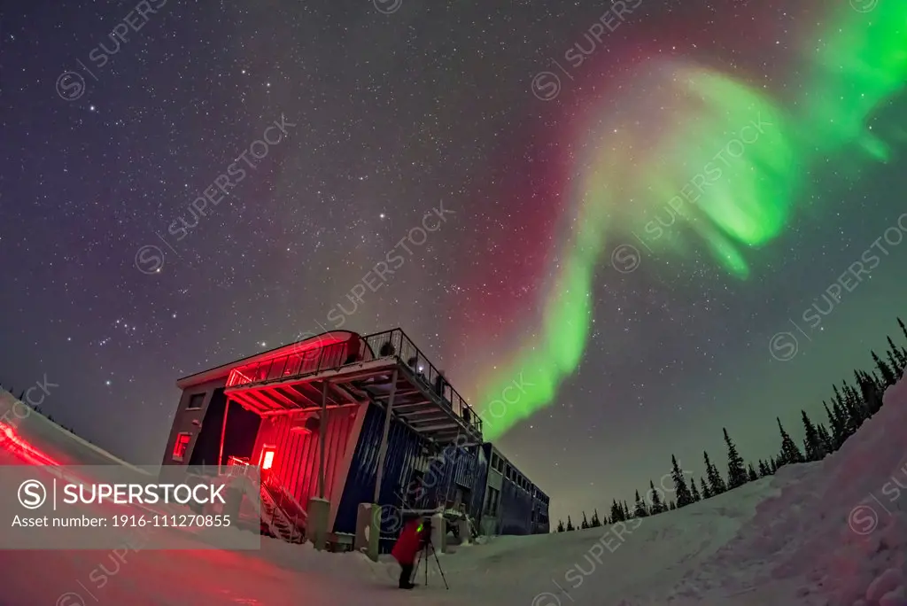 Orion and the winter sky, at left, and a swirl of colourful aurora over the Churchill Northern Studies Centre, in a display on February 11, 2018. People from the first Learning Vacations group of the season are shooting the Lights. This is a single image with the 12mm Rokinon full-frame fish-eye lens and Nikon D750.