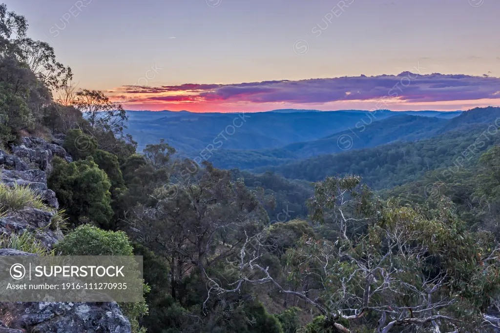 Sunset at Ebor Falls on the Waterfall Way between Armidale and Dorrigo, NSW, Australia. These are the New England Tablelands, but very different from the forests of New England, USA. These are primeval euclalypts, beeches and ferns - a temperate rainforest on the coastal Dividing Range of New South Wales. In this direction we are looking into Guy Fawkes River National Park.This is a high dynamic range stack of 7 exposures to preserve the large range in brightness between the bright sky and dar