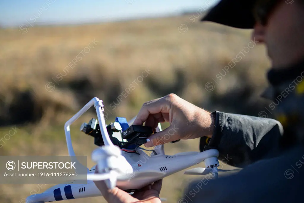 Young man flying Phantom Drone outdoors