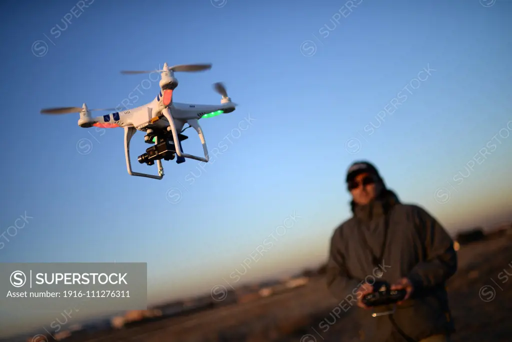 Young man flying Phantom Drone outdoors