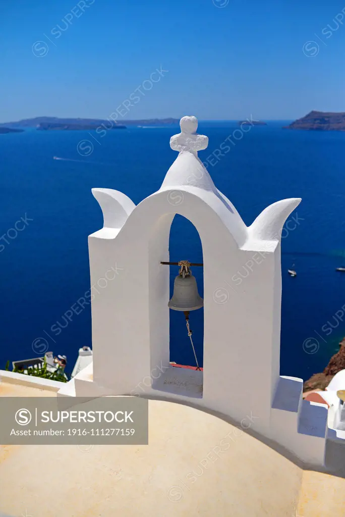 Church bell and hillside buildings in Oia, Santorini, Greek Islands, Greece