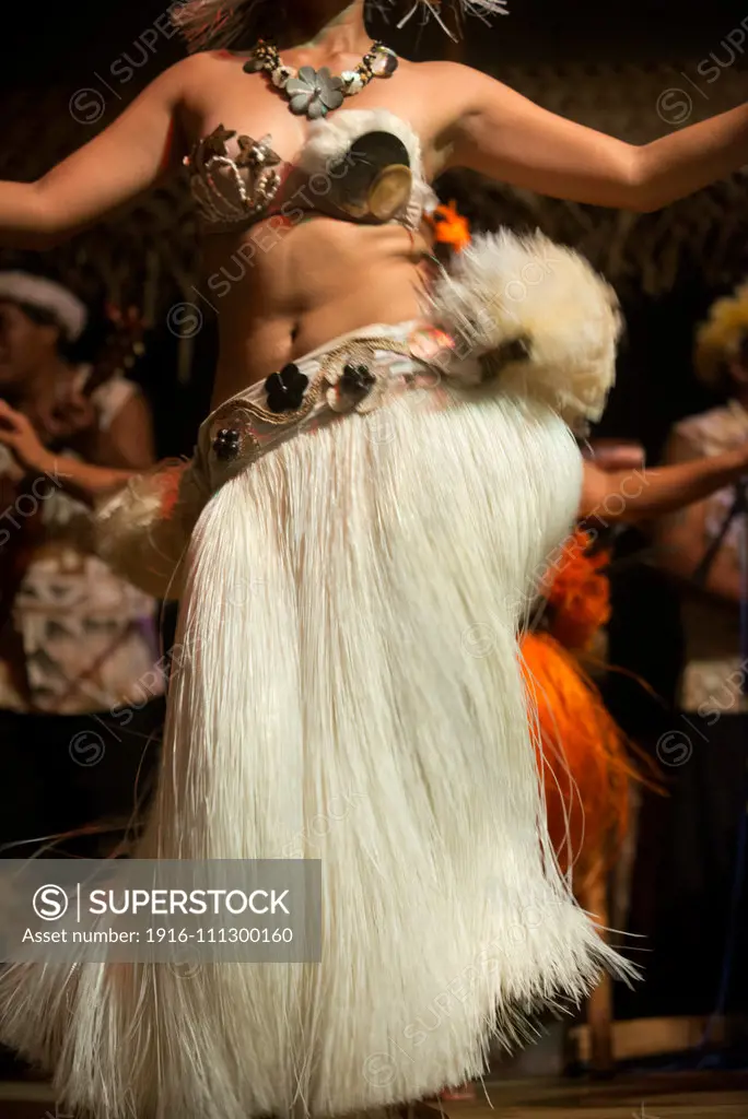 Rarotonga Island. Cook Island. Polynesia. South Pacific Ocean. A woman dances moving her hips in one of the traditional dances of the Cook Island, in Polynesia during the Highland Paradise Cultural Village show.  The music of the Cook Islands is characterized by heavy drums and "frantic ukuleles" and Raro Records is the main specialist in music retail on the islands. Performing groups include the Cook Islands National Arts Theatre, Arorangi Dance Troupe, Betela Dance Troupe, Akirata Folk Dance T