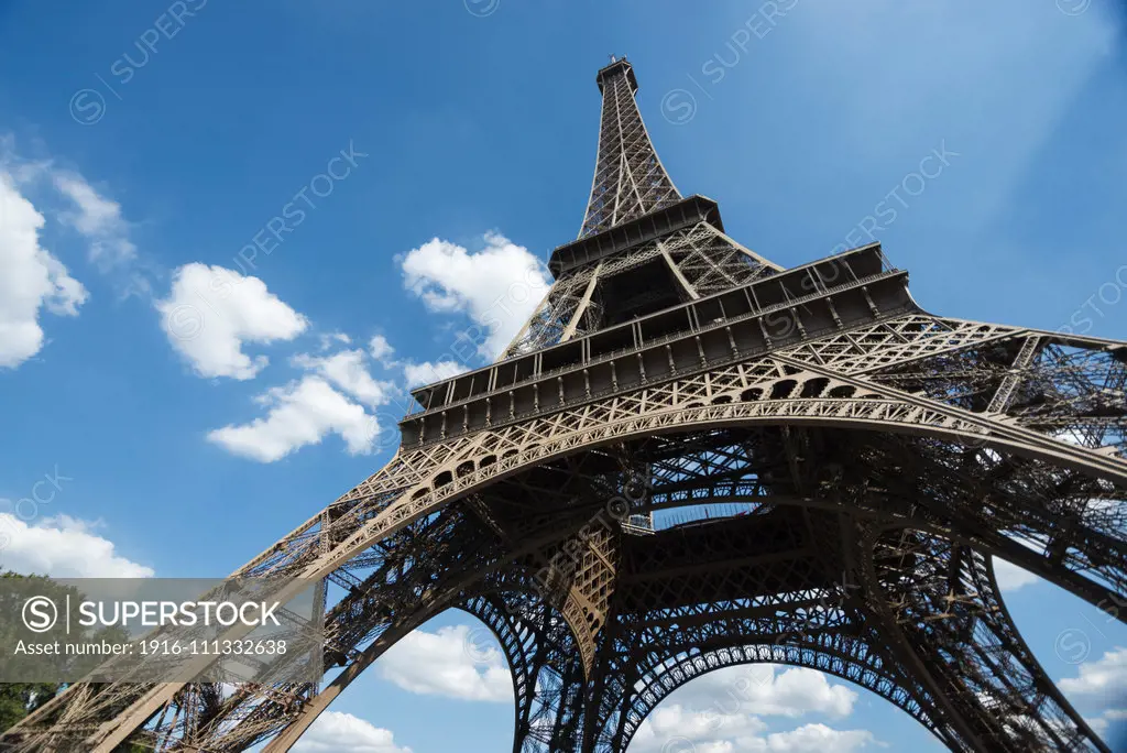 The beautiful Eiffel Tower seen from below on a hot day, Paris, France.