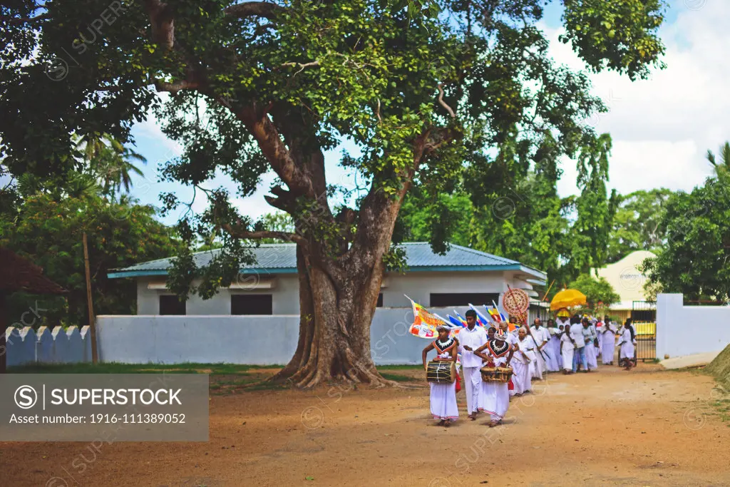 Religious parade at the Sri Maha Bodhi Temple in Anuradhapura. The Sri Maha Bodhi is said to the oldest and longest-surviving tree in the world, which grew from a branch taken from the bodhi tree in Bodh Gaya, India, where Siddhartha Gautama attained enlightenment.