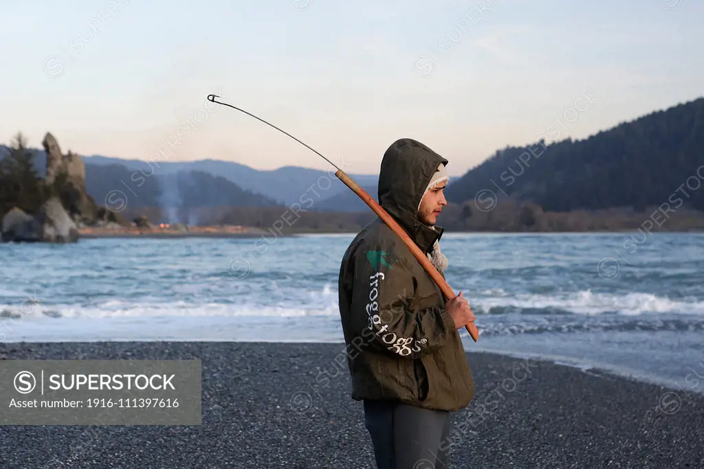 Trevor Avery of the Yurok Indian Tribe fishes for lamprey at the mouth of the Klamath River on the Pacific Ocean on February 24, 2015. Yurok Indian Reservation, California, United States.