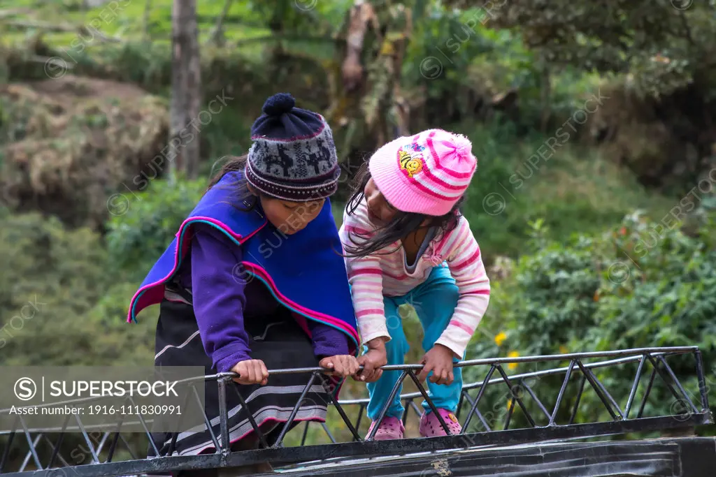 Girls playing on the roof of van.Misak indigenous people, Guambiano inhabits this territory located in the town of Silvia, Cauca. There harvested land, they raise cattle and fish in fish farms, which are then brought to market with handicrafts characteristics of this ethnic group