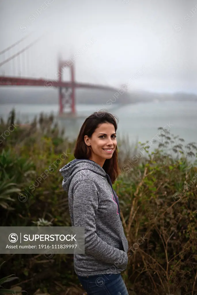 Young woman and Golden Gate Bridge, San Francisco.