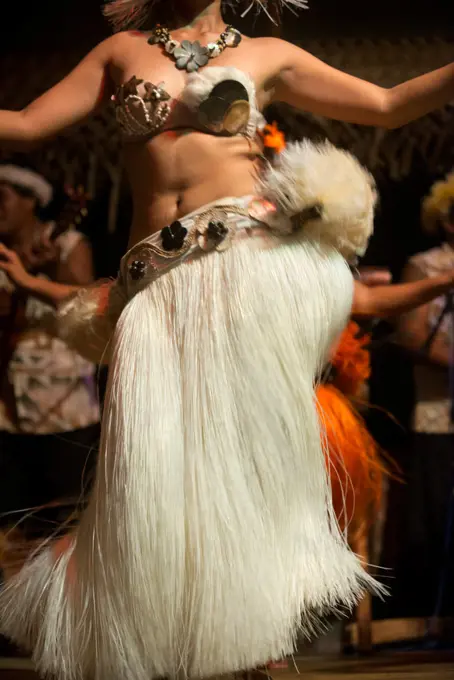 Rarotonga Island. Cook Island. Polynesia. South Pacific Ocean. A woman dances moving her hips in one of the traditional dances of the Cook Island, in Polynesia during the Highland Paradise Cultural Village show.  The music of the Cook Islands is characterized by heavy drums and "frantic ukuleles" and Raro Records is the main specialist in music retail on the islands. Performing groups include the Cook Islands National Arts Theatre, Arorangi Dance Troupe, Betela Dance Troupe, Akirata Folk Dance T