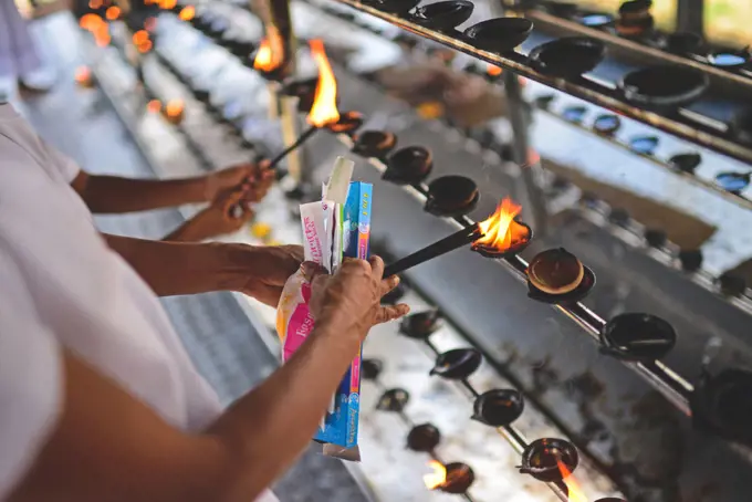 Women light incense in Ruwanwelisaya, a stupa in Anuradhapura, Sri Lanka, considered a marvel for its architectural qualities and sacred to many Buddhists all over the world.