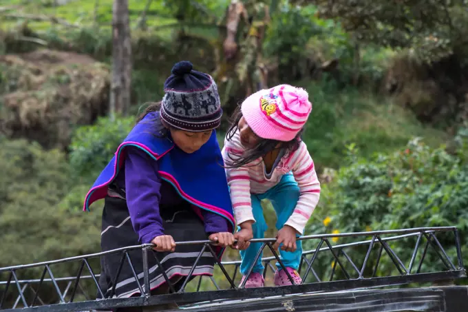 Girls playing on the roof of van.Misak indigenous people, Guambiano inhabits this territory located in the town of Silvia, Cauca. There harvested land, they raise cattle and fish in fish farms, which are then brought to market with handicrafts characteristics of this ethnic group