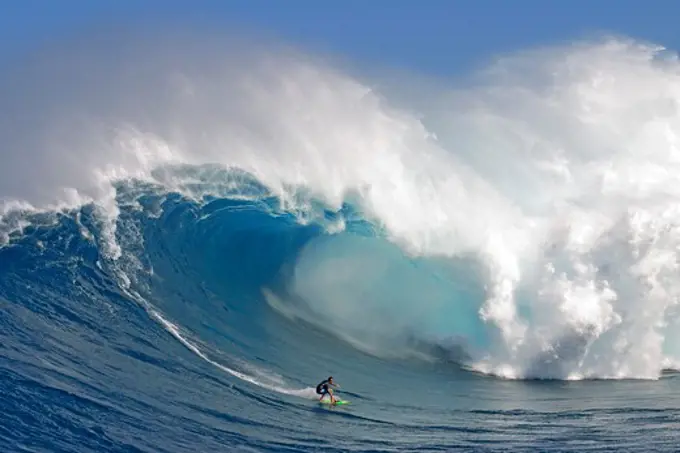 USA, Hawaii, Maui, Peahi, tow-in surfer drops to curl of Hawaii's big surf