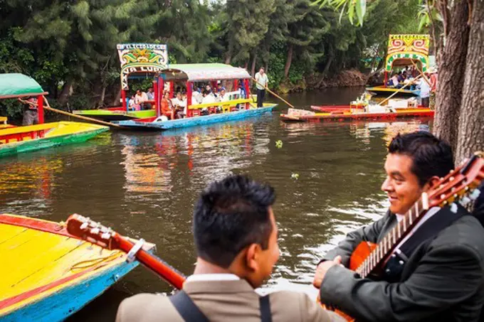 Musicians waiting to be hired and Trajineras on Canal, Xochimilco, Mexico City, Mexico