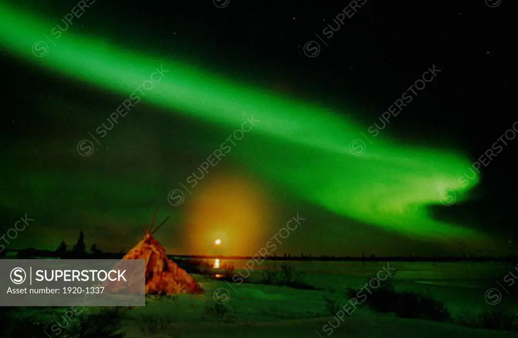 Aurora Borealis Northern Lights full moon over wigwam caribou skin tepee near Churchill Manitoba sub arctic Hudson Bay Northern Canada