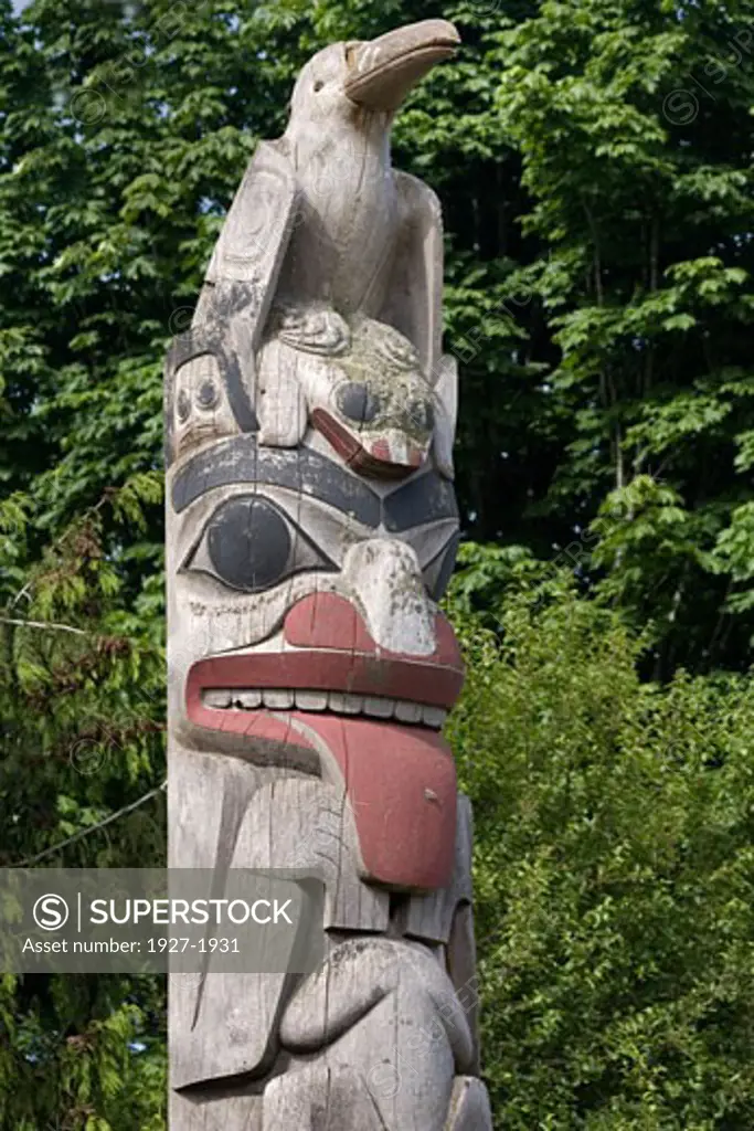 Giant Woodpecker atop totem pole with frog at its feet Museum of Anthropology  Vancouver  Canada